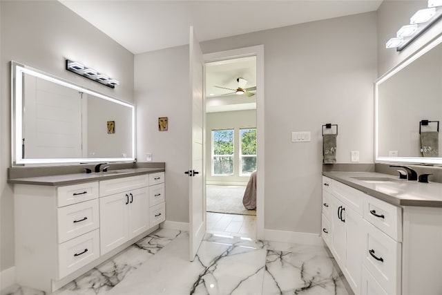 105 Golden Eagle, Horseshoe Bay, TX 78657 - full bath with marble finish flooring, two vanities, baseboards, and ceiling fan