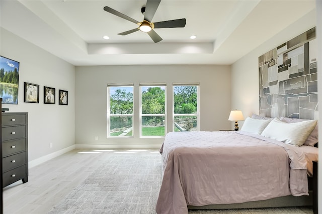 105 Golden Eagle, Horseshoe Bay, TX 78657 - bedroom featuring a tray ceiling, light wood-style flooring, baseboards, ceiling fan, and recessed lighting