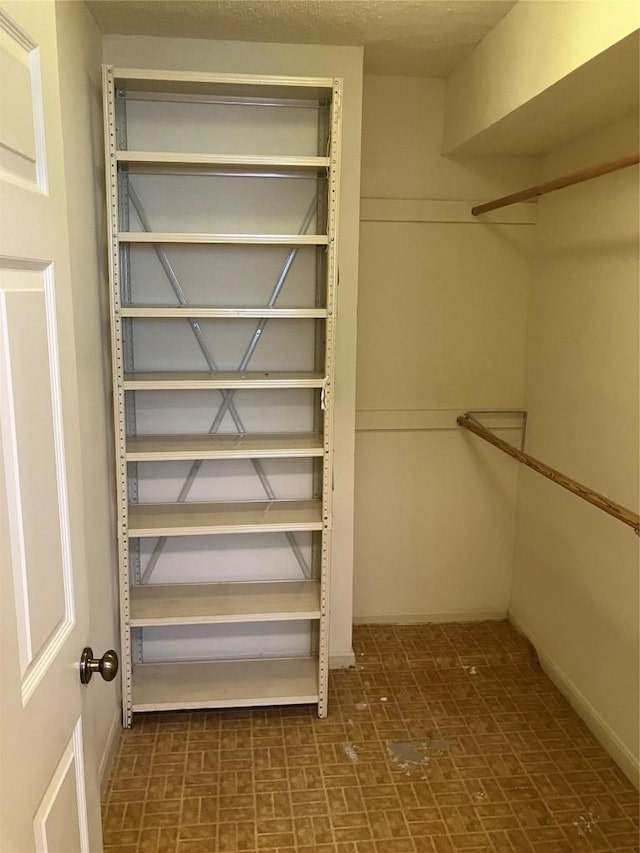7201 Chimney Cors, Austin, TX 78731 - walk in closet featuring tile patterned floors