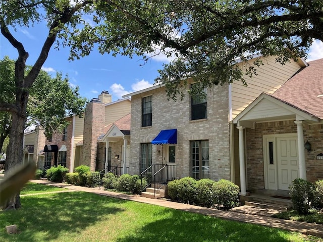 7201 Chimney Cors, Austin, TX 78731 - view of front of property with a front yard and brick siding