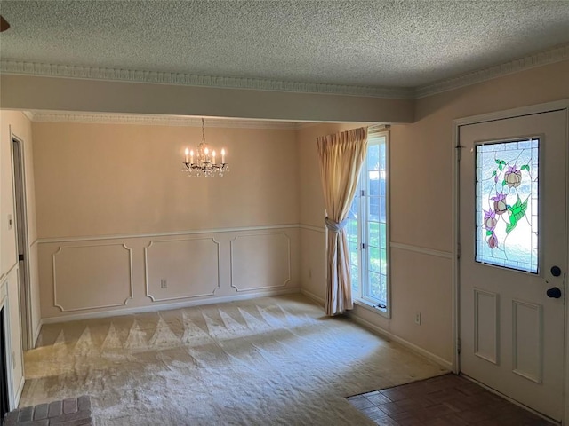 7201 Chimney Cors, Austin, TX 78731 - entryway with a textured ceiling, a chandelier, ornamental molding, a wainscoted wall, and light colored carpet