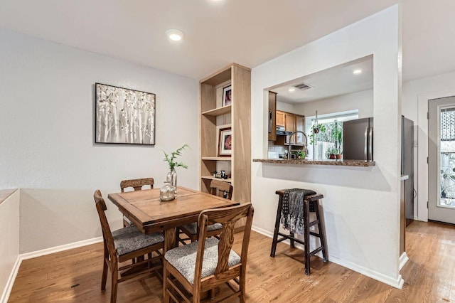 1411 Gracy Farms Ln Unit 113, Austin, TX 78758 - dining room with light wood finished floors, plenty of natural light, recessed lighting, and built in shelves