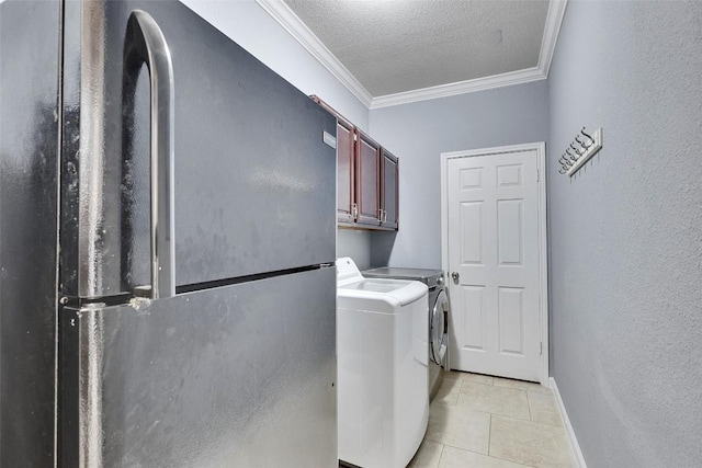 6411 Walebridge Ln, Austin, TX 78739 - laundry room with cabinet space, separate washer and dryer, ornamental molding, light tile patterned floors, and a textured ceiling