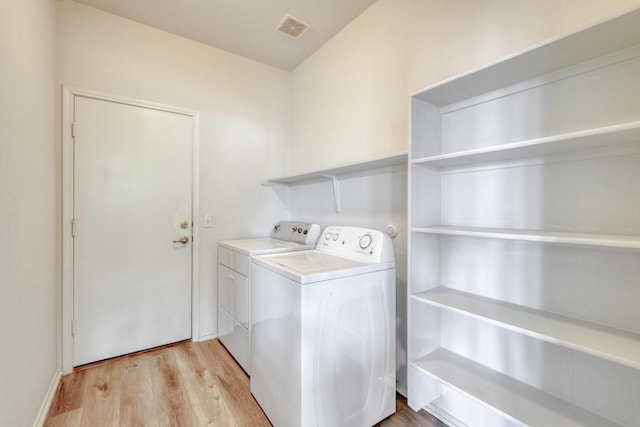 9104 China Rose Dr, Austin, TX 78724 - laundry area featuring washing machine and dryer and light wood-style flooring