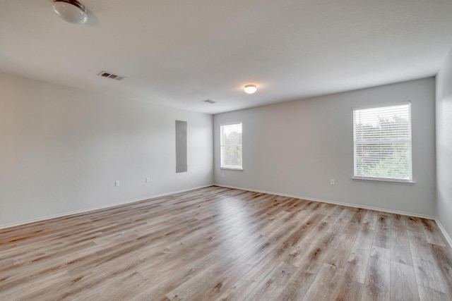 9104 China Rose Dr, Austin, TX 78724 - unfurnished room featuring healthy amount of natural light and light wood-style floors
