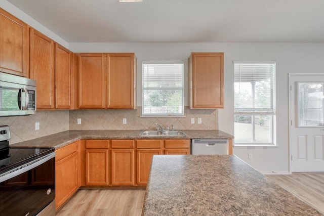 9104 China Rose Dr, Austin, TX 78724 - kitchen with stainless steel appliances, light wood-style floors, and decorative backsplash