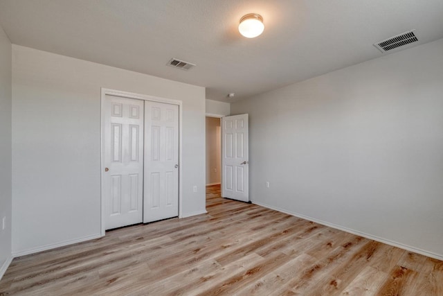 9104 China Rose Dr, Austin, TX 78724 - unfurnished bedroom with light wood finished floors and a closet