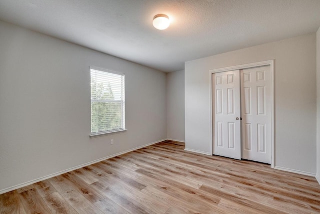 9104 China Rose Dr, Austin, TX 78724 - unfurnished bedroom with light wood-style floors and a closet
