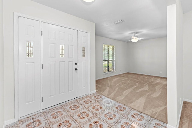 302 Council Rd, Georgetown, TX 78633 - foyer with light colored carpet, baseboards, and a ceiling fan