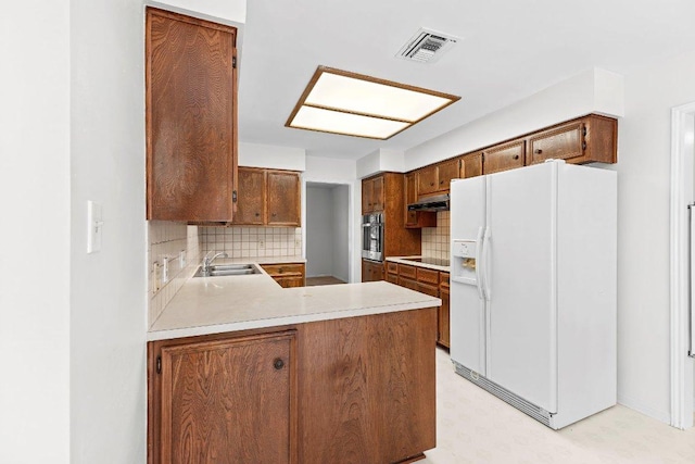 302 Council Rd, Georgetown, TX 78633 - kitchen with white refrigerator with ice dispenser, oven, a sink, under cabinet range hood, and light countertops
