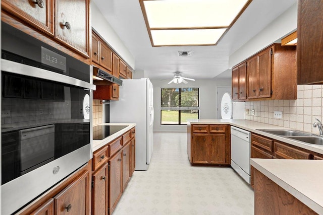 302 Council Rd, Georgetown, TX 78633 - kitchen with white appliances, light flooring, a peninsula, and backsplash