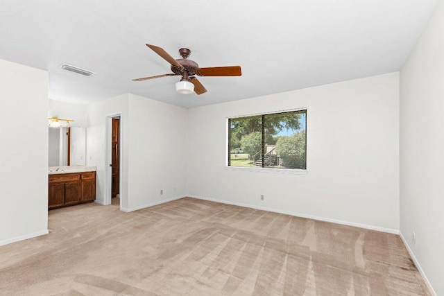 302 Council Rd, Georgetown, TX 78633 - unfurnished bedroom featuring light carpet, baseboards, connected bathroom, and ceiling fan