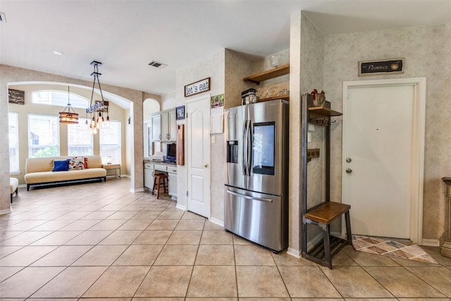 1433 Jenna Ln, Cedar Park, TX 78613 - kitchen with stainless steel fridge with ice dispenser, light tile patterned floors, a chandelier, pendant lighting, and light countertops