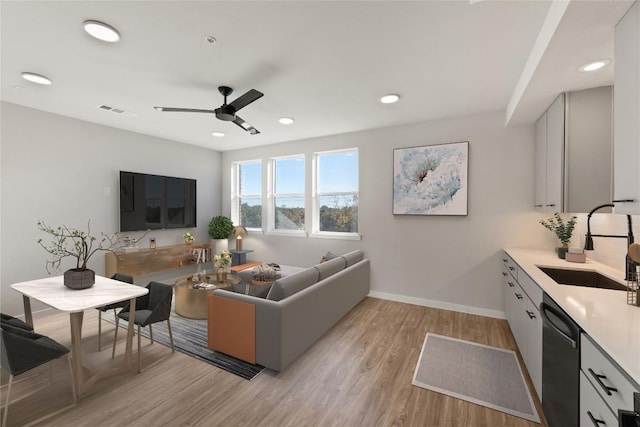 4510 Terryo Ln Unit 139, Austin, TX 78745 - living room featuring light wood-type flooring, ceiling fan, baseboards, and recessed lighting