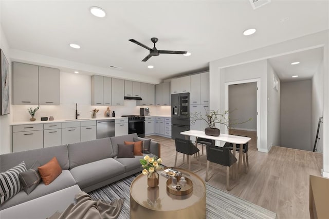 4510 Terryo Ln Unit 139, Austin, TX 78745 - living area with light wood-style flooring, ceiling fan, recessed lighting, and baseboards