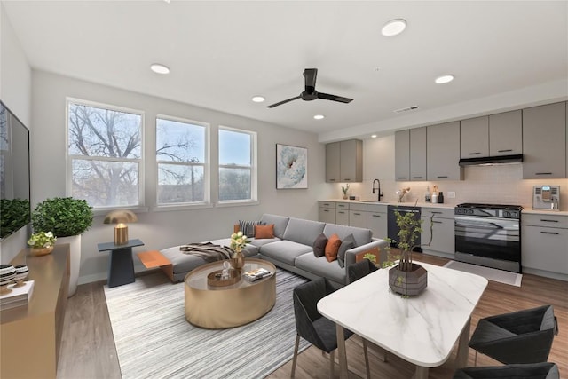 4510 Terryo Ln Unit 139, Austin, TX 78745 - living area featuring plenty of natural light, light wood-type flooring, a ceiling fan, recessed lighting, and baseboards