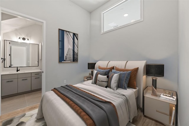 4510 Terryo Ln Unit 139, Austin, TX 78745 - bedroom with a sink, light wood-style floors, and ensuite bath