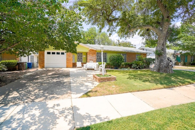 2607 Monticello Ct, San Antonio, TX 78223 - view of front of home with brick siding, driveway, a garage, and a front yard