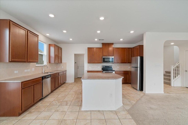 14302 Honey Gem Dr, Pflugerville, TX 78660 - kitchen with appliances with stainless steel finishes, a sink, backsplash, light tile patterned floors, and recessed lighting
