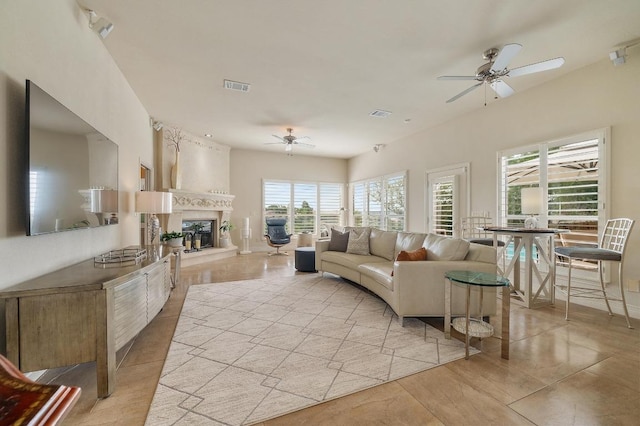 20503 Hoover Cv, Lago Vista, TX 78645 - living area with a ceiling fan, a fireplace, and light tile patterned floors