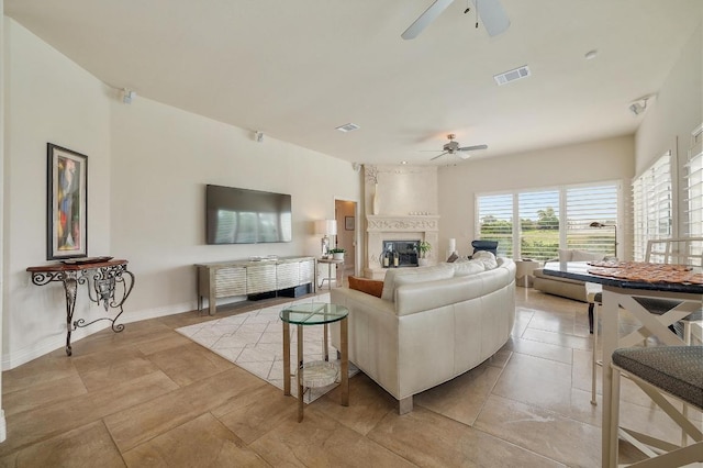 20503 Hoover Cv, Lago Vista, TX 78645 - living area with ceiling fan, a large fireplace, light tile patterned flooring, and baseboards