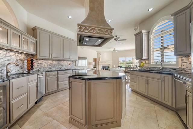 20503 Hoover Cv, Lago Vista, TX 78645 - kitchen with a ceiling fan, stainless steel dishwasher, premium range hood, decorative backsplash, and a kitchen island
