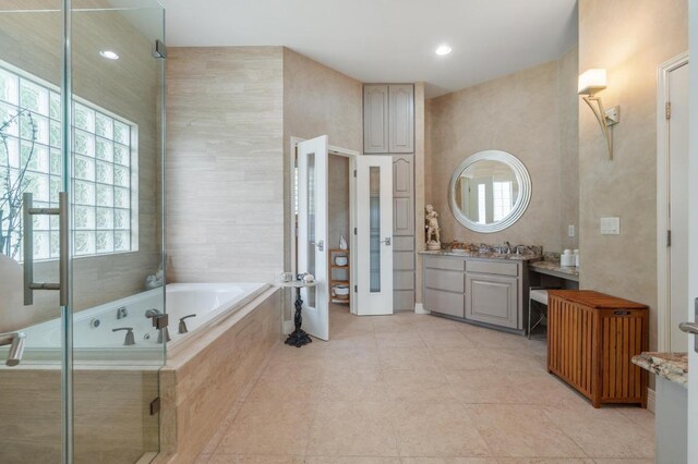 20503 Hoover Cv, Lago Vista, TX 78645 - bathroom featuring vanity, a bath, tile patterned flooring, a stall shower, and recessed lighting