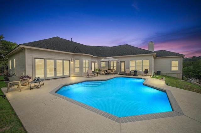 20503 Hoover Cv, Lago Vista, TX 78645 - pool at dusk with a patio, french doors, and an outdoor pool