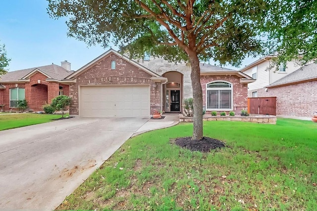320 Atlanta Park Dr, Georgetown, TX 78628 - view of front facade with an attached garage, a front lawn, and brick siding