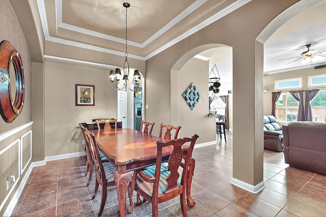 320 Atlanta Park Dr, Georgetown, TX 78628 - dining space with a ceiling fan, arched walkways, ornamental molding, tile patterned flooring, and a raised ceiling