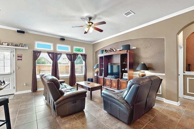 320 Atlanta Park Dr, Georgetown, TX 78628 - living room with arched walkways, ceiling fan, crown molding, and baseboards