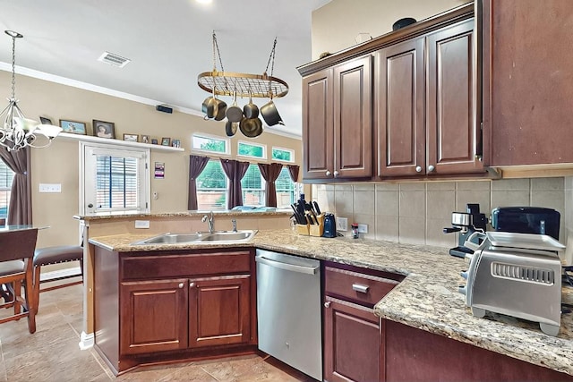 320 Atlanta Park Dr, Georgetown, TX 78628 - kitchen with stainless steel dishwasher, a sink, a chandelier, a peninsula, and ornamental molding
