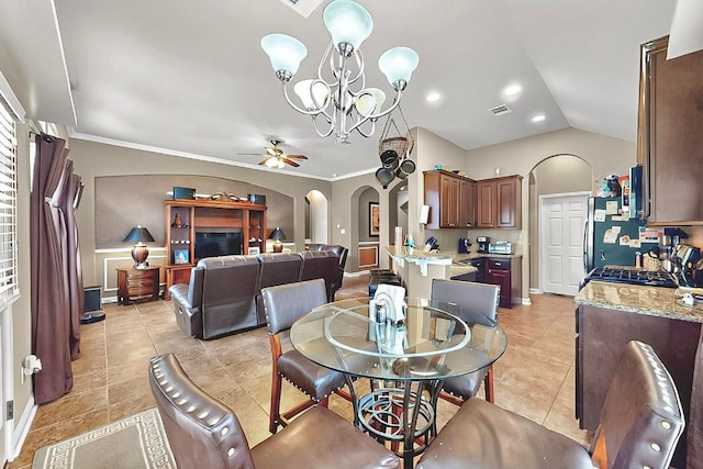 320 Atlanta Park Dr, Georgetown, TX 78628 - dining room featuring arched walkways, ceiling fan, light tile patterned floors, lofted ceiling, and a chandelier