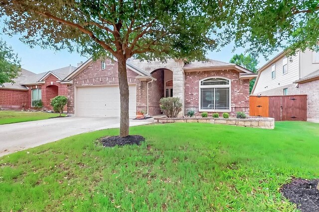 320 Atlanta Park Dr, Georgetown, TX 78628 - view of front of home with a garage, driveway, and brick siding