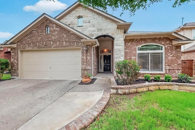 320 Atlanta Park Dr, Georgetown, TX 78628 - french provincial home featuring a garage, concrete driveway, brick siding, and stone siding