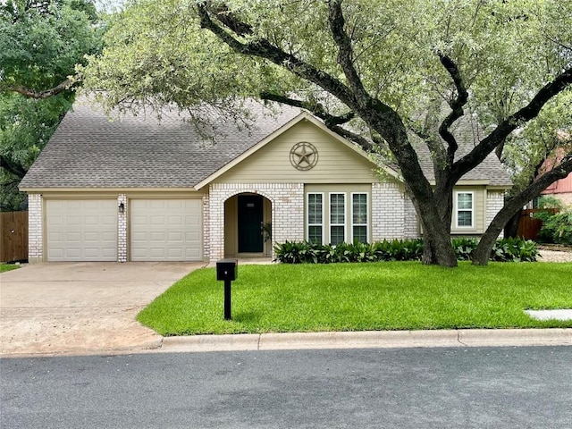 4107 Columbine Dr, Austin, TX 78727 - view of front of home featuring a garage, concrete driveway, brick siding, and a shingled roof