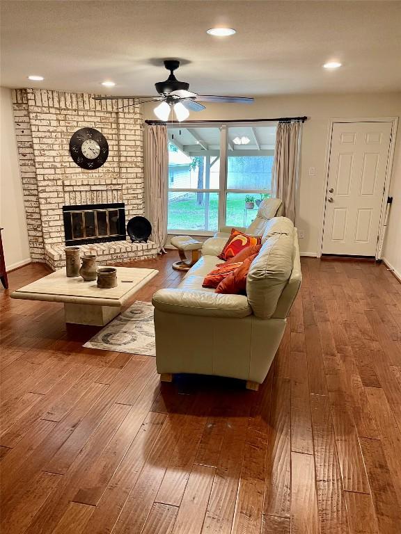 4107 Columbine Dr, Austin, TX 78727 - living area with wood-type flooring, ceiling fan, a brick fireplace, and recessed lighting