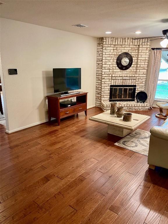 4107 Columbine Dr, Austin, TX 78727 - living area with hardwood / wood-style floors, a brick fireplace, ceiling fan, baseboards, and recessed lighting
