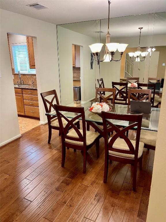 4107 Columbine Dr, Austin, TX 78727 - dining area featuring light wood finished floors, a chandelier, and baseboards