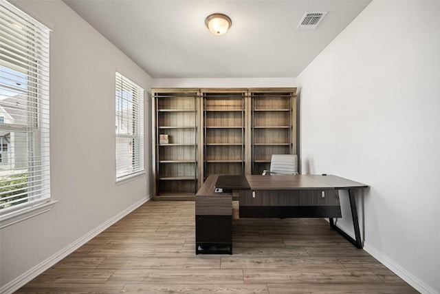 265 Fawn River Run, Kyle, TX 78640 - unfurnished office with baseboards and wood finished floors
