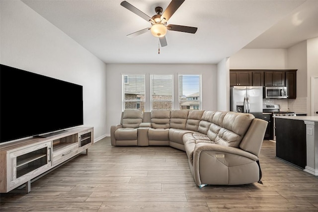 265 Fawn River Run, Kyle, TX 78640 - living room with ceiling fan, light wood-type flooring, and baseboards