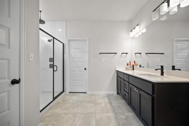 265 Fawn River Run, Kyle, TX 78640 - bathroom featuring double vanity, a stall shower, tile patterned floors, and baseboards