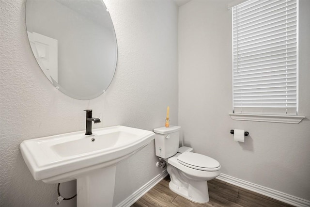 265 Fawn River Run, Kyle, TX 78640 - bathroom with wood finished floors, baseboards, toilet, and a sink