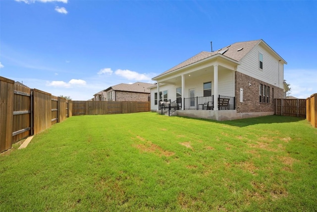 265 Fawn River Run, Kyle, TX 78640 - rear view of house with brick siding and a patio area