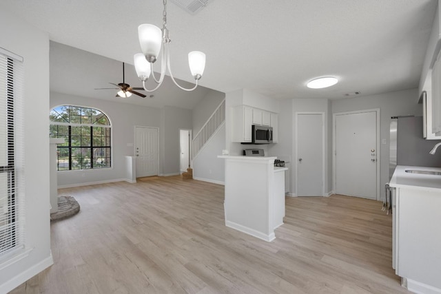 8407 Mount Shasta Cv, Round Rock, TX 78681 - kitchen featuring stainless steel microwave, a sink, ceiling fan, white cabinetry, and light wood-style flooring