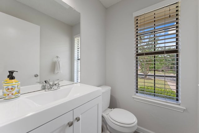 8407 Mount Shasta Cv, Round Rock, TX 78681 - half bathroom with plenty of natural light, toilet, vanity, and baseboards
