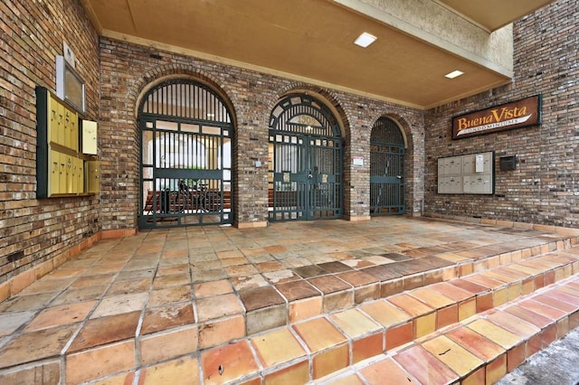 1908 San Antonio St Unit 313, Austin, TX 78705 - wine room with brick wall, stone tile flooring, and a towering ceiling