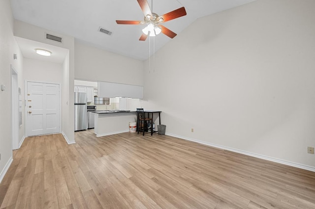 1908 San Antonio St Unit 313, Austin, TX 78705 - unfurnished living room featuring high vaulted ceiling, ceiling fan, light wood finished floors, and baseboards