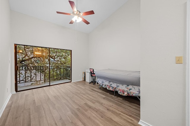 1908 San Antonio St Unit 313, Austin, TX 78705 - unfurnished bedroom with high vaulted ceiling, wood finished floors, baseboards, access to outside, and a ceiling fan