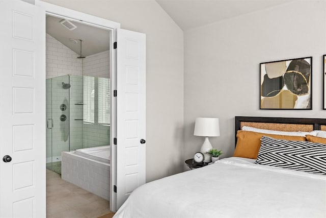 286 Canal Dr, Dripping Springs, TX 78620 - tiled bedroom with vaulted ceiling and connected bathroom